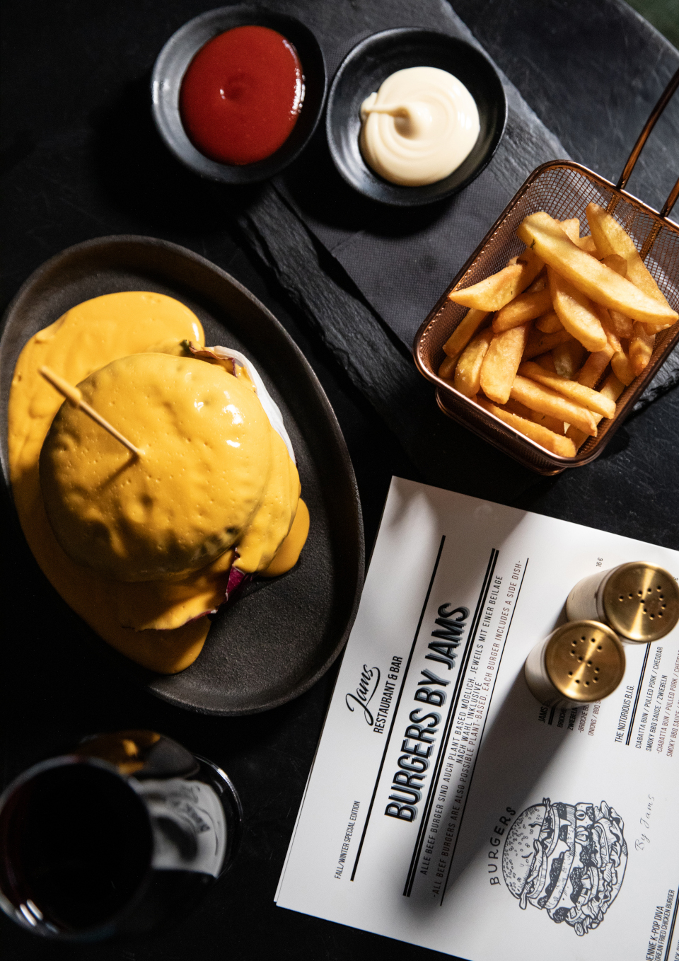 Signature Burger menu and a glass of wine at JAMS Hotel Munich.